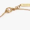 Halsband med manschettknapp i ljusguld Halsband med manschettknapp i ljusguld